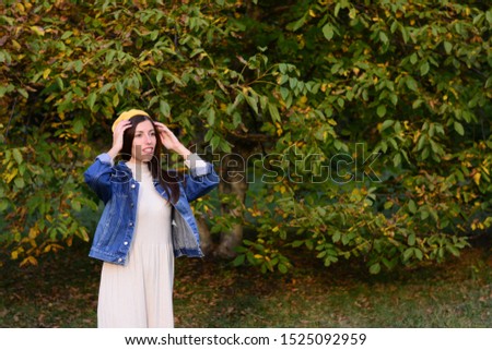 woman in a jacket with a yellow beret on her head nature forest