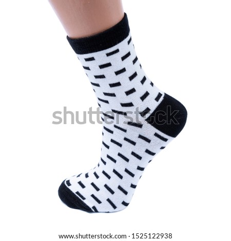 white and black  socks in the cage and stripes or polka dot on a white isolated background