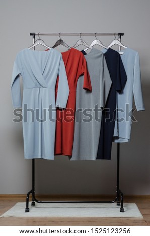 new stylish dress collection on the hangers of clothing rack rails. fashion design studio 
