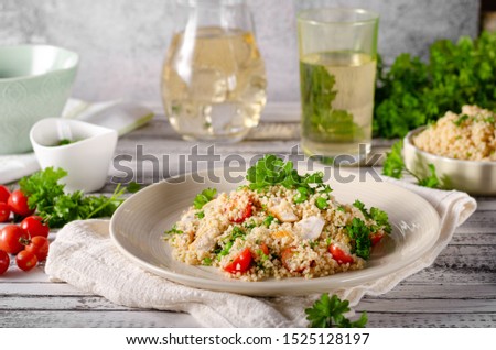 Bio couscous with chicken meat, tomatoes and fresh herbs