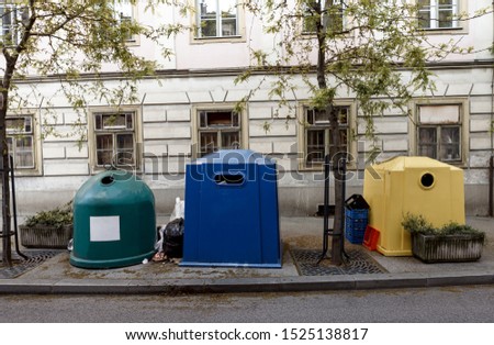 View of the plastic trash cans standing next to each other in front of the building on the street of Zagreb, Croatia. Save the world. 