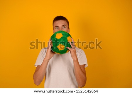 man with ball on a yellow background soccer sport