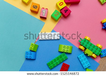 Colorful child kid’s education toys constructor pattern background on the bright color background close up. Childhood education infancy children baby concept