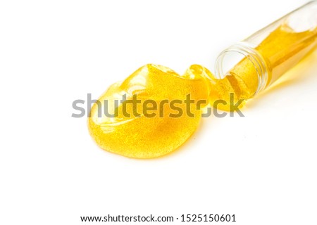 Toy called slime spilling from the jar. Transparent yellow mucus isolated on a white background. Selective focus	 Royalty-Free Stock Photo #1525150601