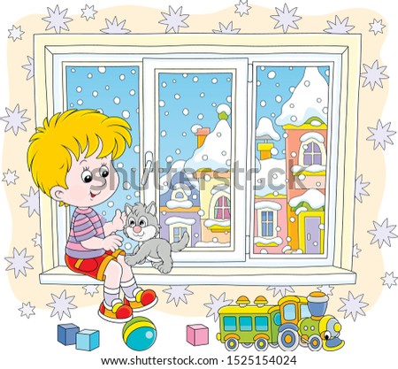 Cheerful little boy playing with his small grey kitten on the windowsill of a nursery on a snowy winter day, vector illustration in a cartoon style