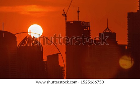 Dubai Marina skyscrapers from golf course sunset timelapse, Dubai, United Arab Emirates. Aerial view from Greens district. Close up view and orange sky