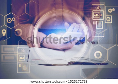 Businesswoman in brown shirt using smartphone at office table with double exposure of HUD digital interface. Concept of big data and hi tech. Toned image