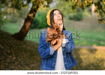 woman walks in the park in autumn yellow leaves