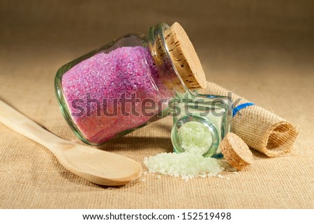 bath salts of different colors isolated on rustic background