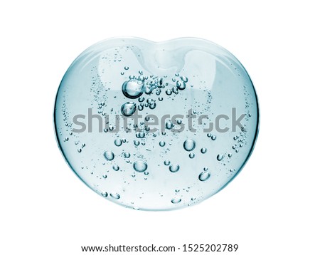 Squeezed cosmetic clear cream gel texture Iisolated on white background. Close up photo of transparent drop of skin care product. High Quality transparent gel with bubbles closeup on white background Royalty-Free Stock Photo #1525202789