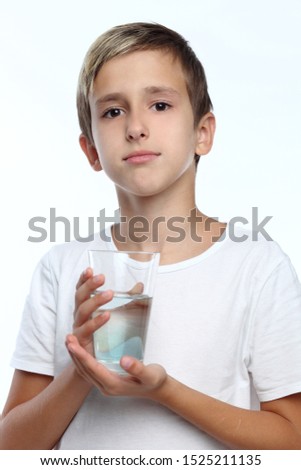 kid caring for teeth. Spray a disinfectant mouthwash in the throat