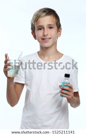 kid caring for teeth. Cute boy with white background, wearing braces on his teeth.