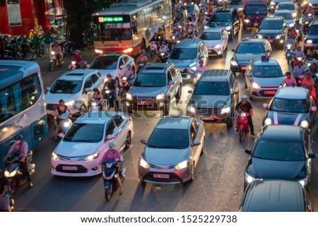 Blurred car traffic background at rush hour in Hanoi street, Vietnam Royalty-Free Stock Photo #1525229738