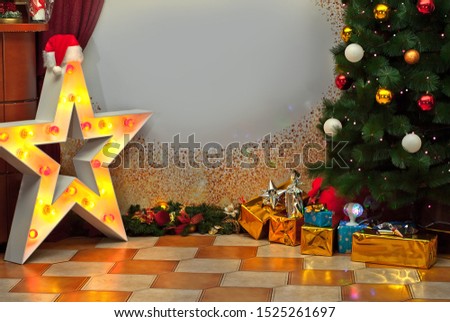 Christmas gifts near the Christmas tree. Holiday photo zone with decorations and decor. Part of the room is hung with Santa Claus garlands and hats. Free space for text on paper background.