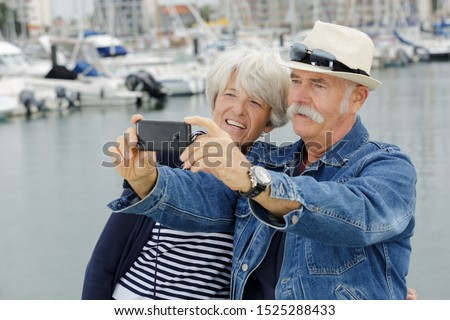 a senior couple taking selfie