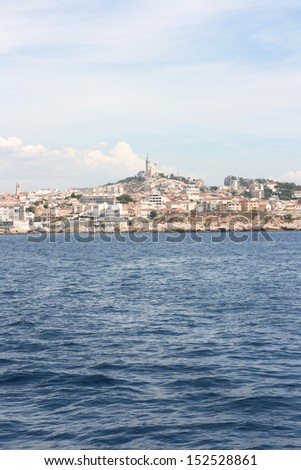 Panoramic view of Marseille with Notre dame de la garde basilica in the background. Picture shot from the sea.Marseille is a part of french riviera in south of France.