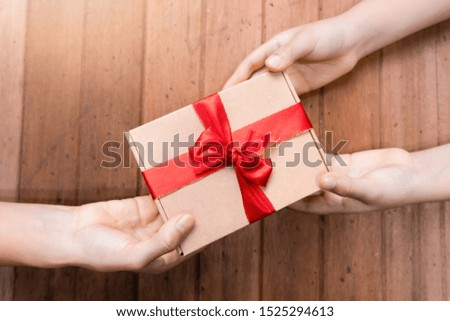 Hands hold gifts on New Year Day