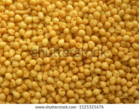 Yellow color salted fried Boondi spicy Indian snack made from chickpea flour Royalty-Free Stock Photo #1525321676