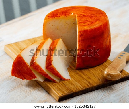 Picture of tasty french goat cheese with pepper at wooden desk