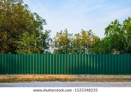 Texture of profiled metal. Metal fence. Green metallic corrugated fence Royalty-Free Stock Photo #1525348235