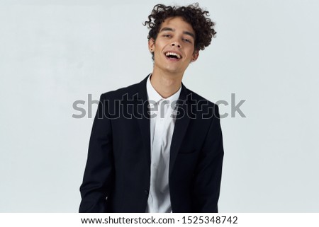 Cheerful business man curly hair suit gray background Professional