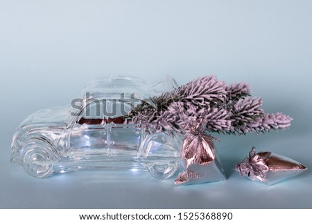 Glass vase with spruce branch and gifts. Decor for the New Year and Christmas.
