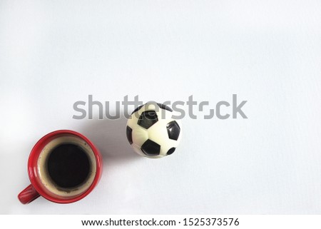 Football and coffee cup on the white background top view