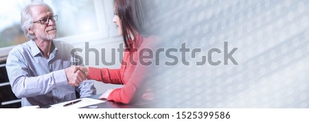 Handshake between woman and man at office after interview, light effect; panoramic banner