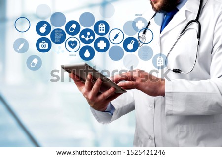 Doctor with digital tablet and variety medical icons
