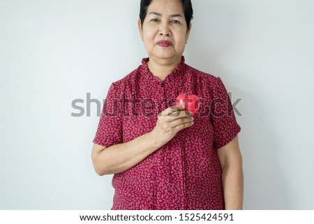 Red heart model on senior woman hands,Health Care and cardiology concept