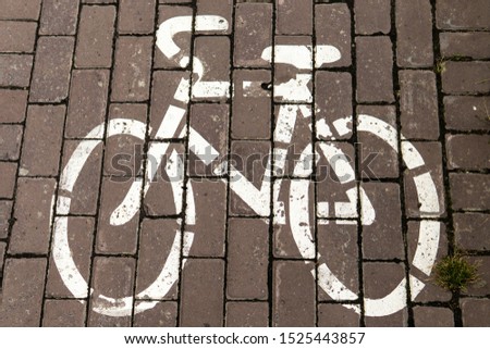 Top view on road markings and bike path symbol on the sidewalk