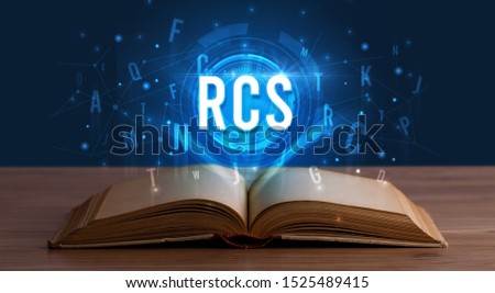 RCS inscription coming out from an open book, digital technology concept