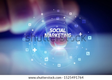 Finger touching tablet with social media icons and SOCIAL MARKETING