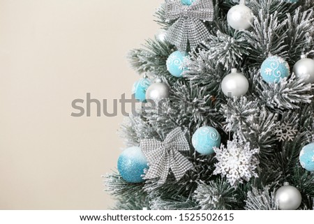 Beautiful Christmas tree with decor against light background. Space for text