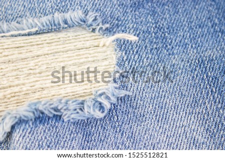 Ripped destroyed in wash blue denim jeans. isolated background