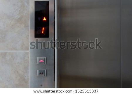 Metallic elevator panel with button and led display.  Interior and closeup of metal buttons in elevator