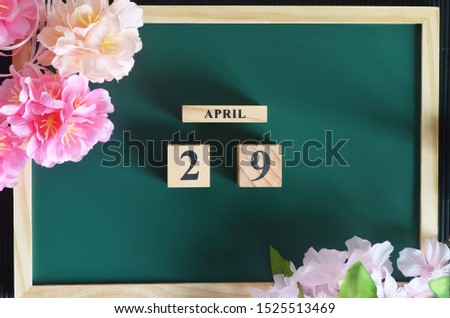 Japanese Cover, Number cube with sakura flower on the wood green board, April 29.