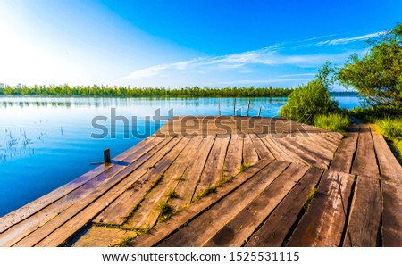 River pier view. Lake pier Royalty-Free Stock Photo #1525531115