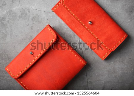 Set of two Wallets and organizer made of genuine red leather, handmade on a dark background.