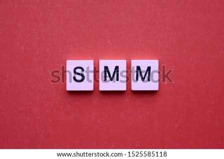 SMM word wooden cubes on a red background