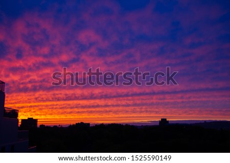 Sunset over Montreal. Picture taken on Nuns Island. Clouds colors are pink, lavender, orange and purple.