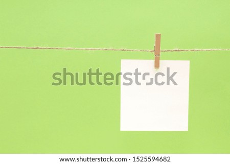 blank white sticker on a rope on a  colored background