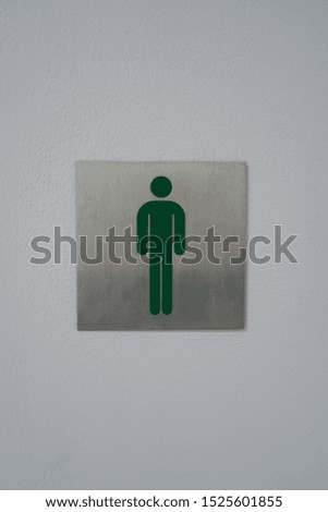 Male toilet sign on the wall.