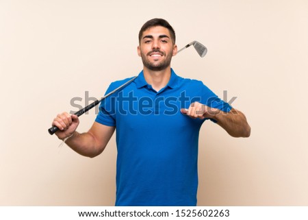 Young handsome golfer man over isolated background proud and self-satisfied