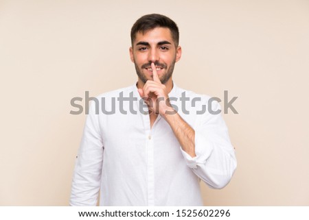 Handsome man with beard over isolated background doing silence gesture