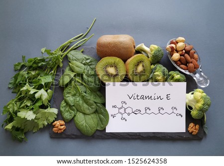 Food rich in vitamin E with structural chemical formula of vitamin E molecule. Natural products containing vitamins, dietary fiber and minerals. Healthy sources of vitamin E, healthy diet food. Royalty-Free Stock Photo #1525624358