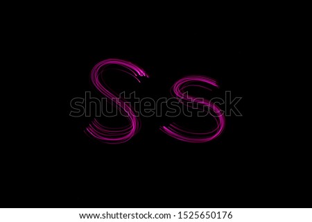 Long exposure photograph of the letter s in upper case and lower case, in neon pink colour in an abstract swirl, parallel lines pattern against a black background. Light painting photography.