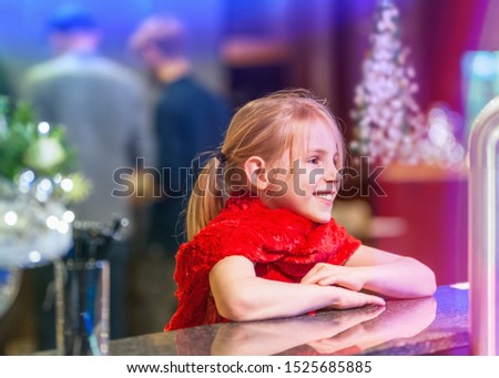 Girl sits at a bar at a Christmas party in a location