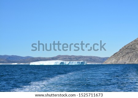icebergs in the arctic sea from the Eqip Sermia - Eqi Glacier in Greenland. Boat trip in the Disko Bay. World heritage -  extremly affected by global warming and climate change. Summer - July