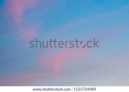 Pink sunset clouds and blue sky